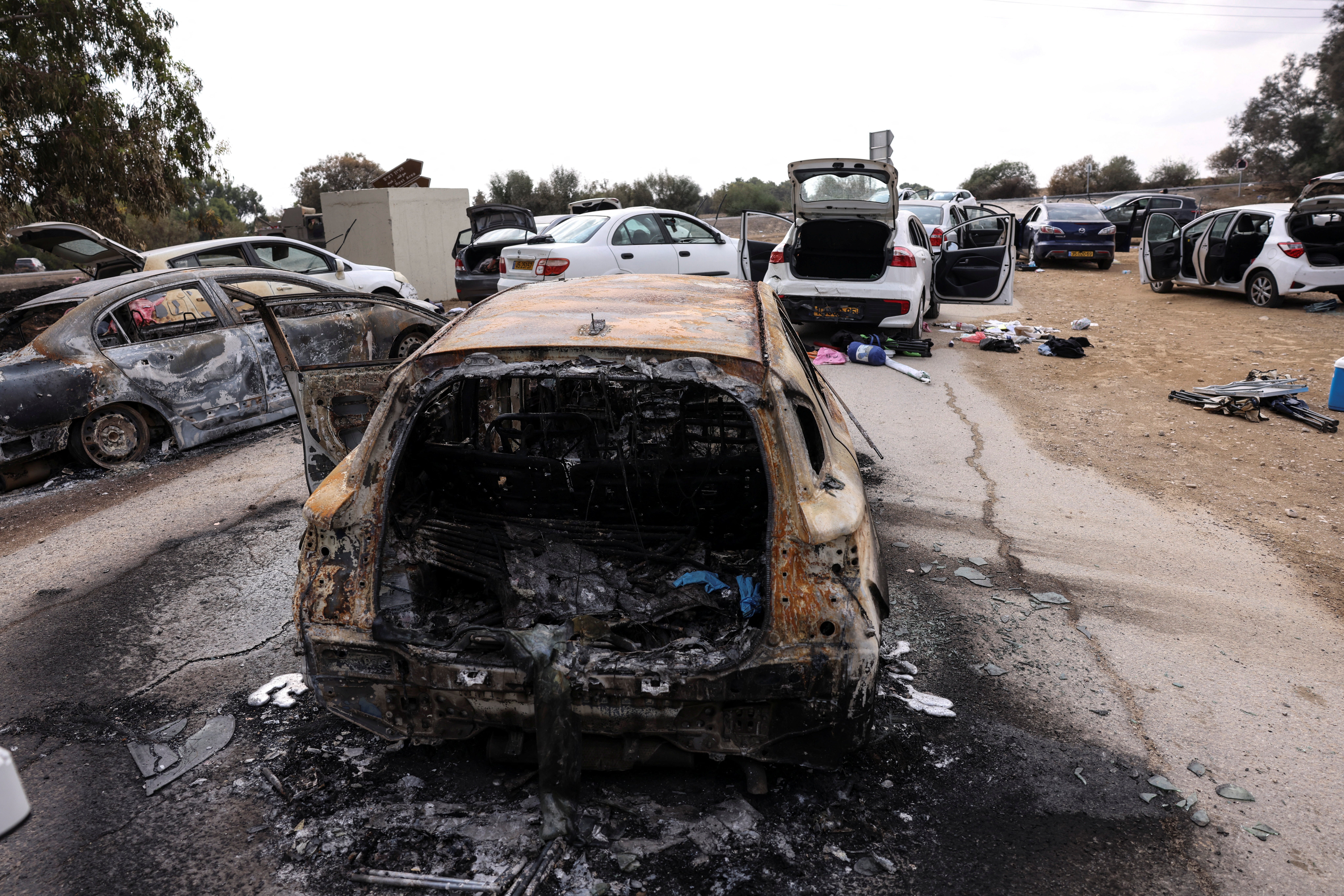 Burnt cars are abandoned in a carpark near the Hamas festival attack