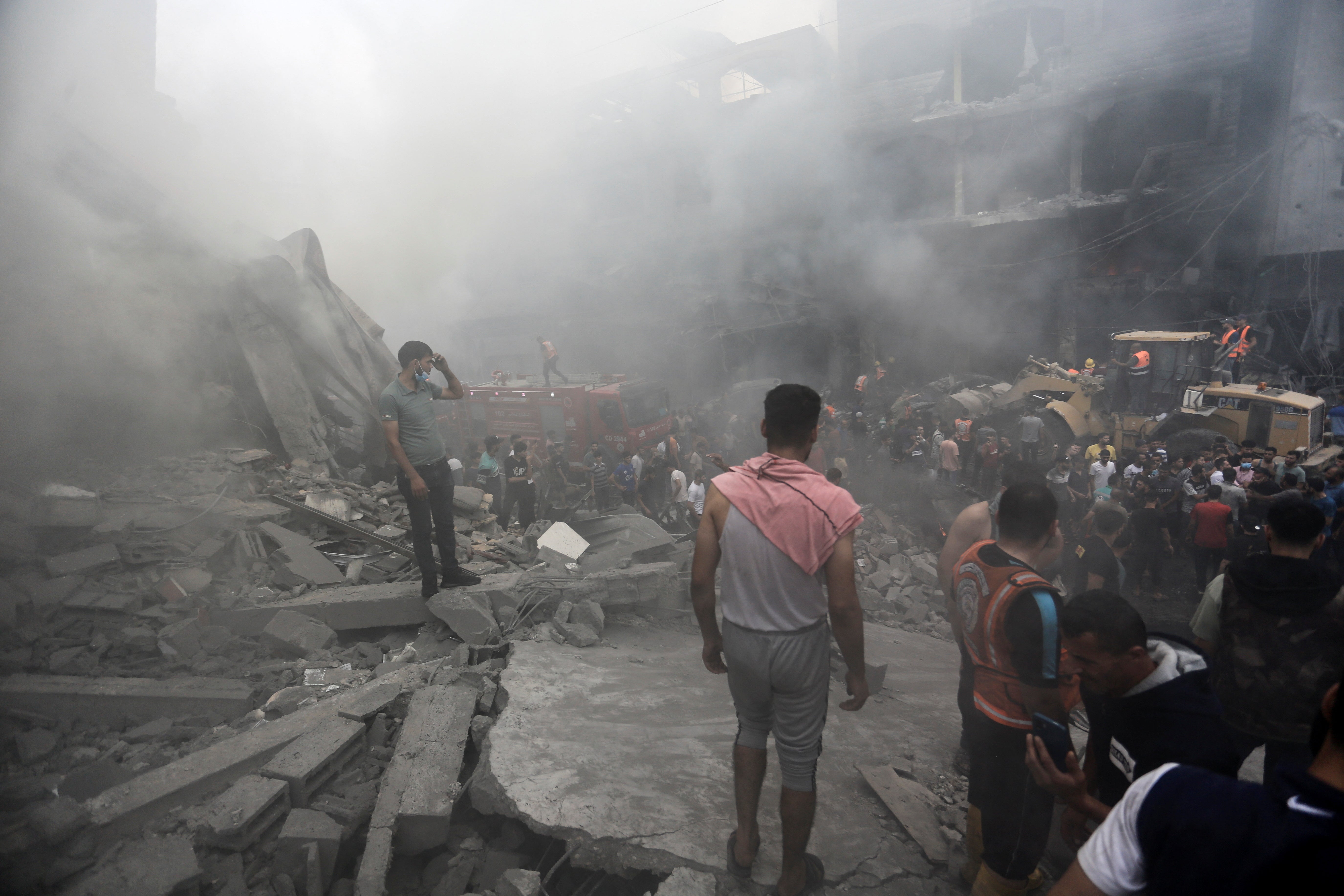 Palestinians gather at the site of Israeli strikes, in Jabalia refugee camp