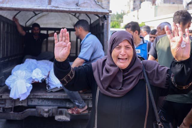 <p>A Palestinian woman reacts as bodies of people killed in overnight Israeli shelling arrive for their funeral in Khan Yunis in the southern Gaza Strip, on 10 October</p>
