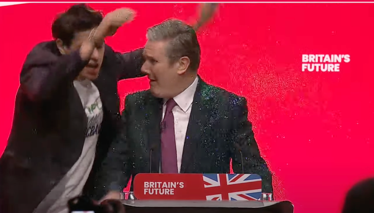 Intruder storms stage for Keir Starmer speech and throws glitter over Labour leader