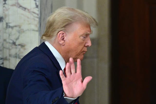<p>Donald Trump waves after speaking to media during the third day of his civil fraud trial in New York on 3 October. </p>