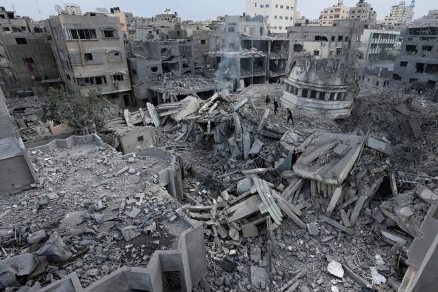 <p>Palestinians inspect the rubble of the Yassin Mosque destroyed after it was hit by an Israeli airstrike at Shati refugee camp in Gaza City, early Monday, 9 October 2023</p>
