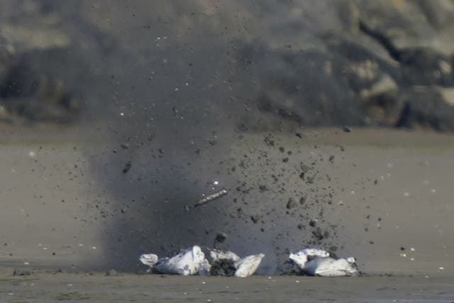 A controlled explosion is carried out on a suspect package, at Sandymount Strand, Sandymount in Dublin (Niall Carson/PA)