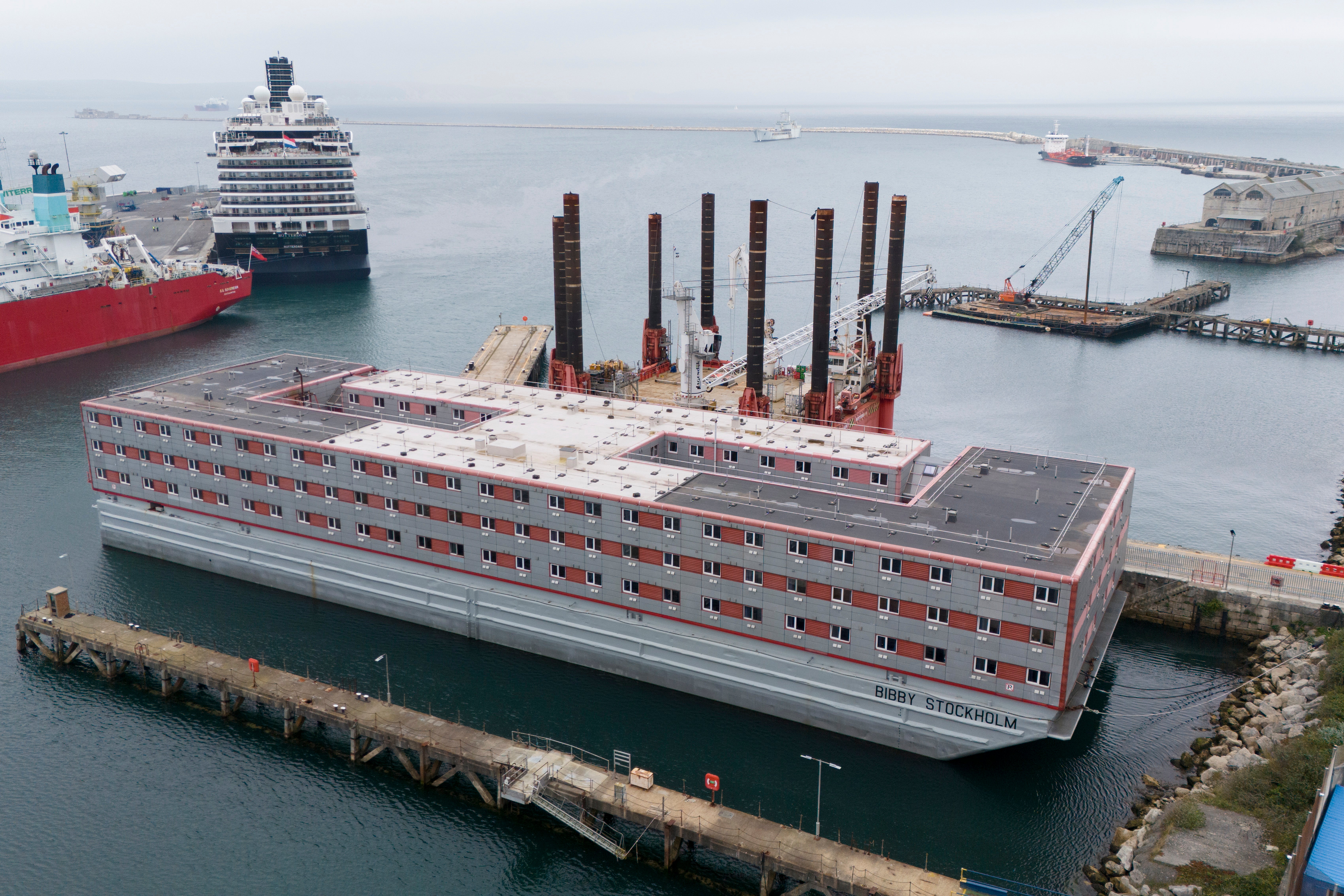 An image taken with a drone shows the Bibby Stockholm barge docked in Portland Port, Dorset