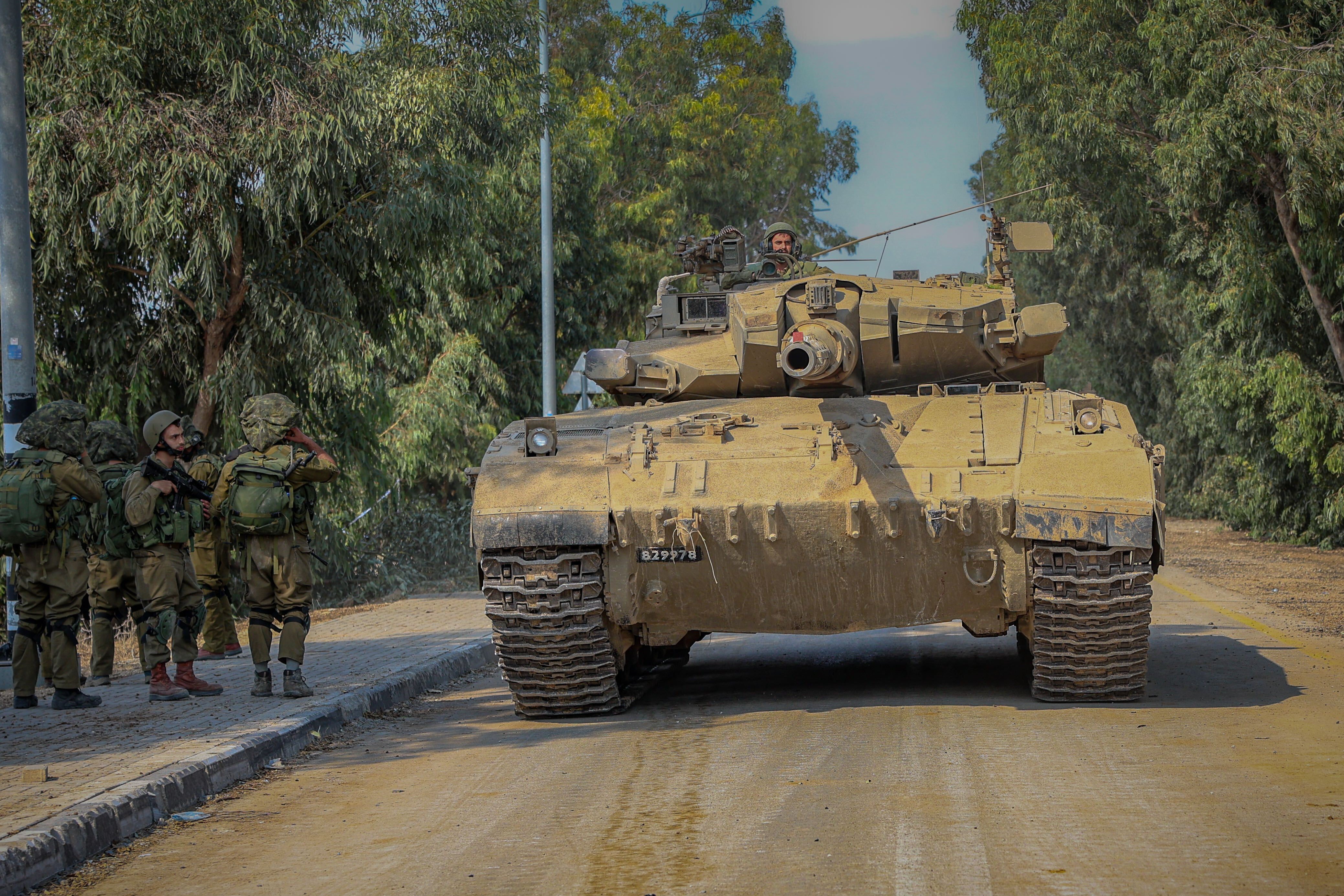 An Israeli tank and soldiers in Kfar Aza