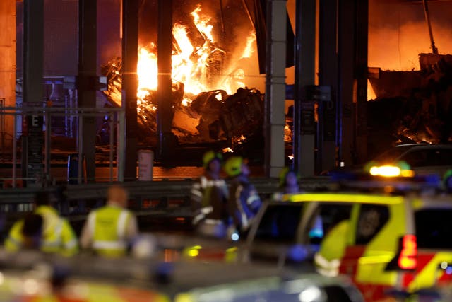 <p>Flames are seen as emergency services respond to a fire in Terminal Car Park 2 at London Luton Airport</p>