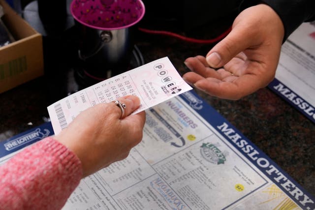 <p>A customer purchases five Powerball tickets at a lottery agent, Tuesday, Oct. 10, 2023, in Haverhill, Mass. After 35 straight drawings without a big winner, Powerball players will have a shot Wednesday at a near-record jackpot worth an estimated $1.73 billion. (AP Photo/Charles Krupa)</p>