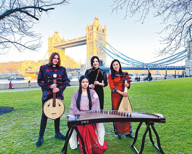 <p>UK Chinese Ensemble members pose in front of London’s Tower Bridge after a performance in 2022</p>