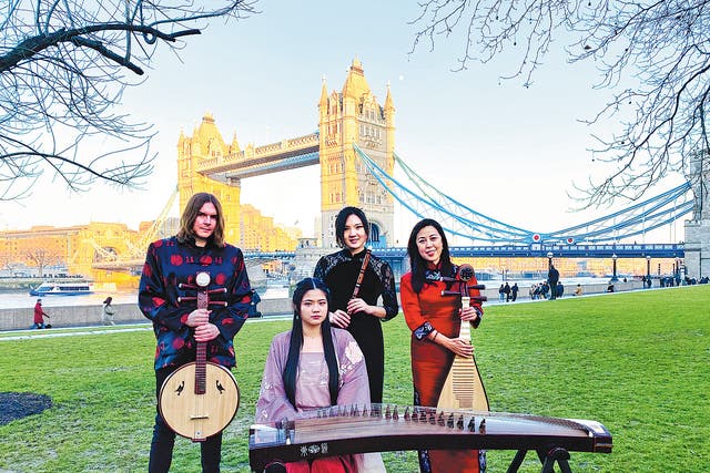 <p>UK Chinese Ensemble members pose in front of London’s Tower Bridge after a performance in 2022</p>