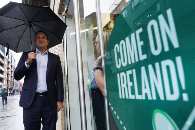Taoiseach Leo Varadkar speaks to a shop worker during a morning canvass of commuters at Mayor Square in Dublin (Brian Lawless/PA)