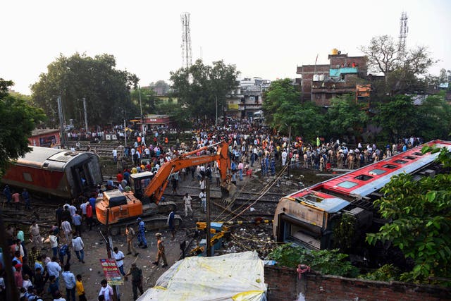 <p>Rescuers and other gather around coaches of the North-East Express passenger train that derailed in Buxar district of Bihar state, India</p>
