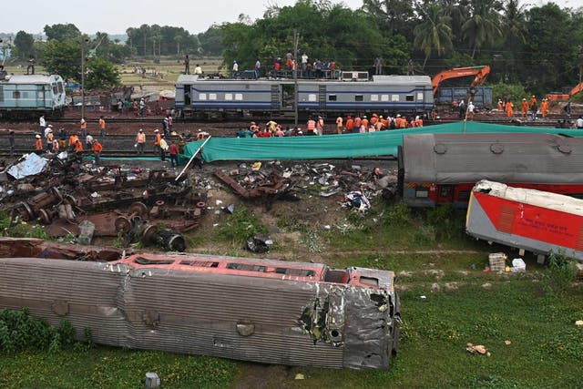 <p>Railway workers help to restore services at the accident site of a three-train collision near Balasore in June, 2023 </p>