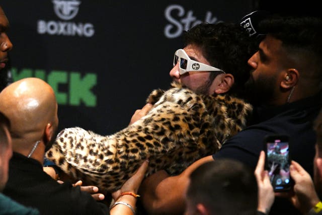 <p>Dillon Danis is held back after striking Logan Paul at their pre-fight face-off</p>