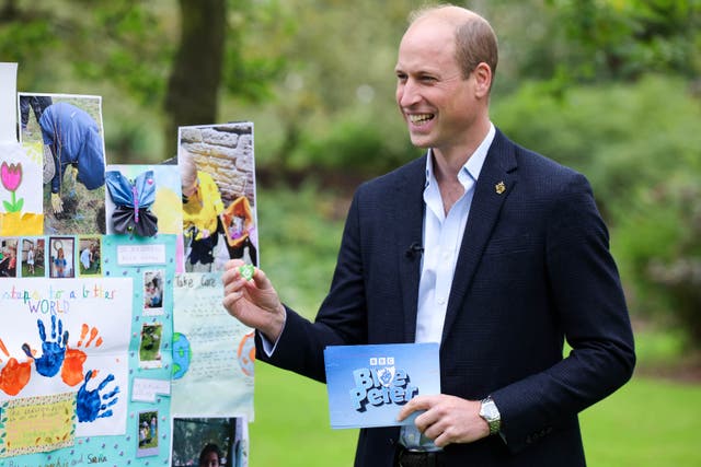 The Prince of Wales looks at a wall showing drawings and writing about the environment by Blue Peter fans (Andrew Parsons/Kensington Palace/PA)