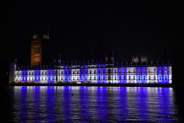 The Palace of Westminster is lit up in the colours of Israel’s flag for victims and hostages of Hamas attacks (Lucy North/PA)