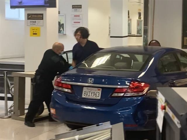 <p>A man who was later killed by police, gets out of his car after crashing into the lobby of the Chinese Consulate in San Francisco.</p>