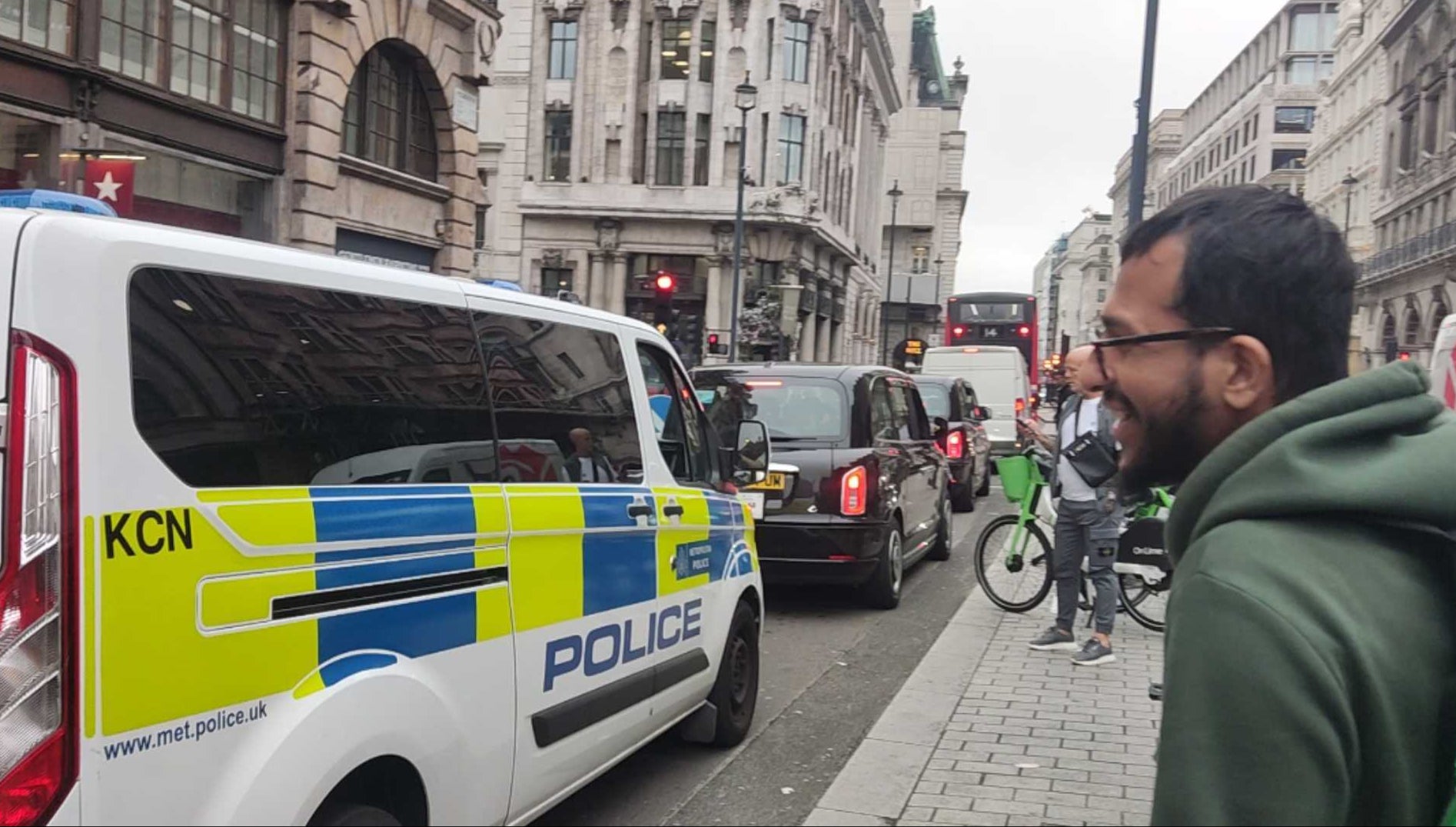 Shaf waves at unimpressed police officers stuck in traffic