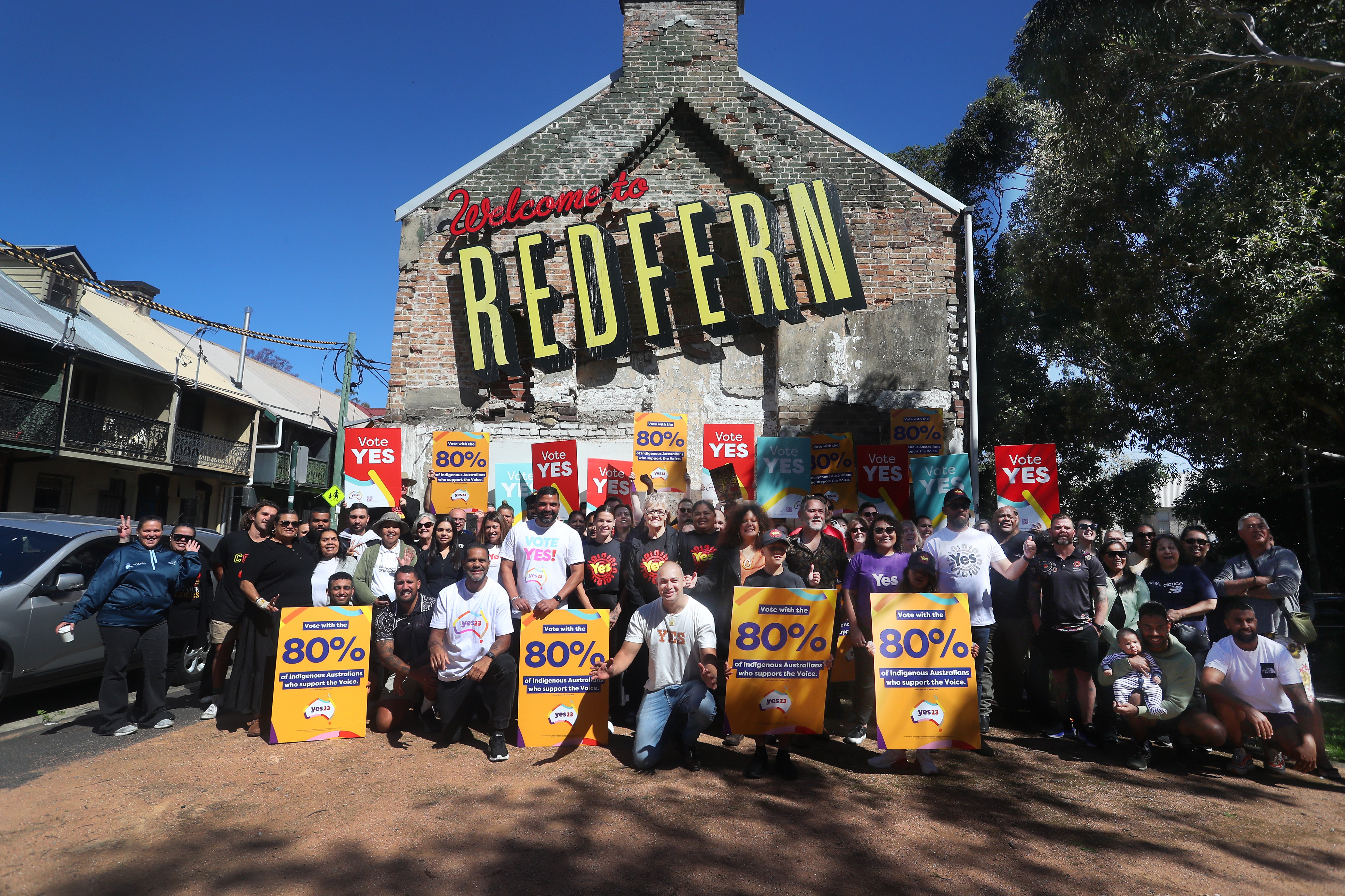 Yes23 supporters hold placards as they gather for a photo during an event at the Redfern Community Centre