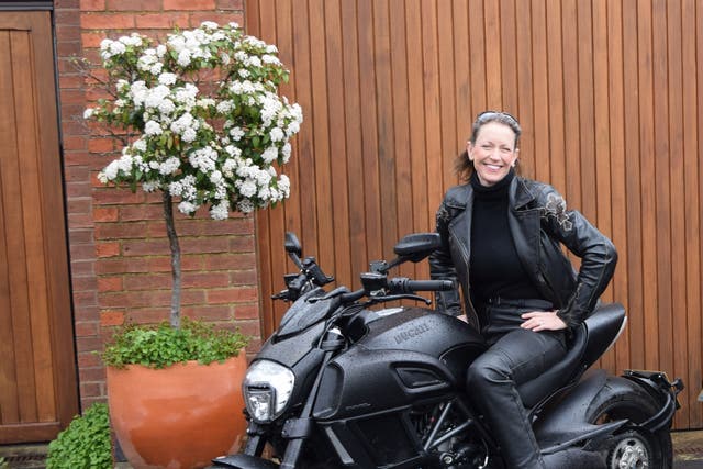 <p>Frieda and her beloved Ducati Diavel – one of several motorbikes in her stable</p>