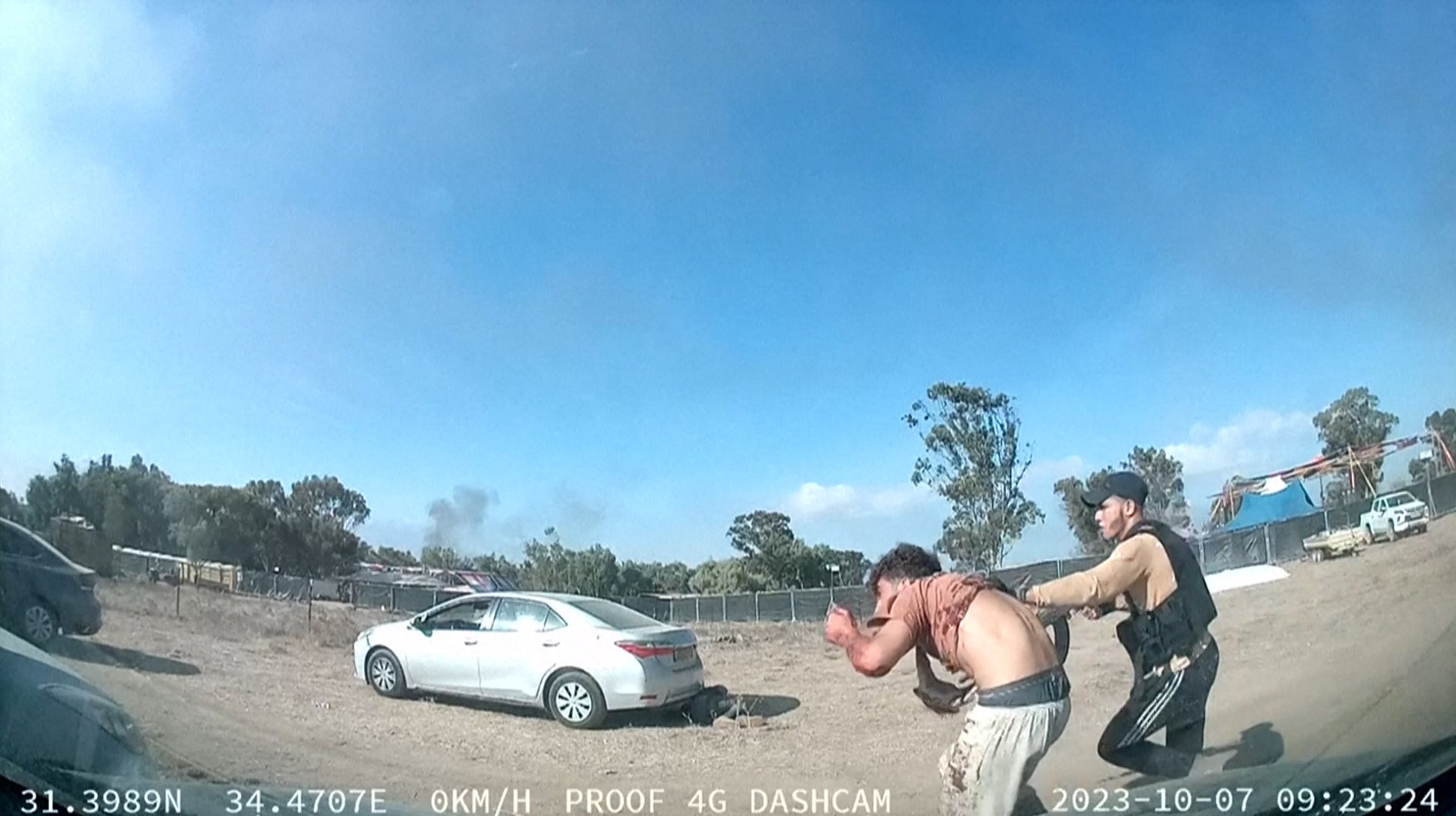 Dashcam footage shows a member of Hamas leading an individual along during the attack