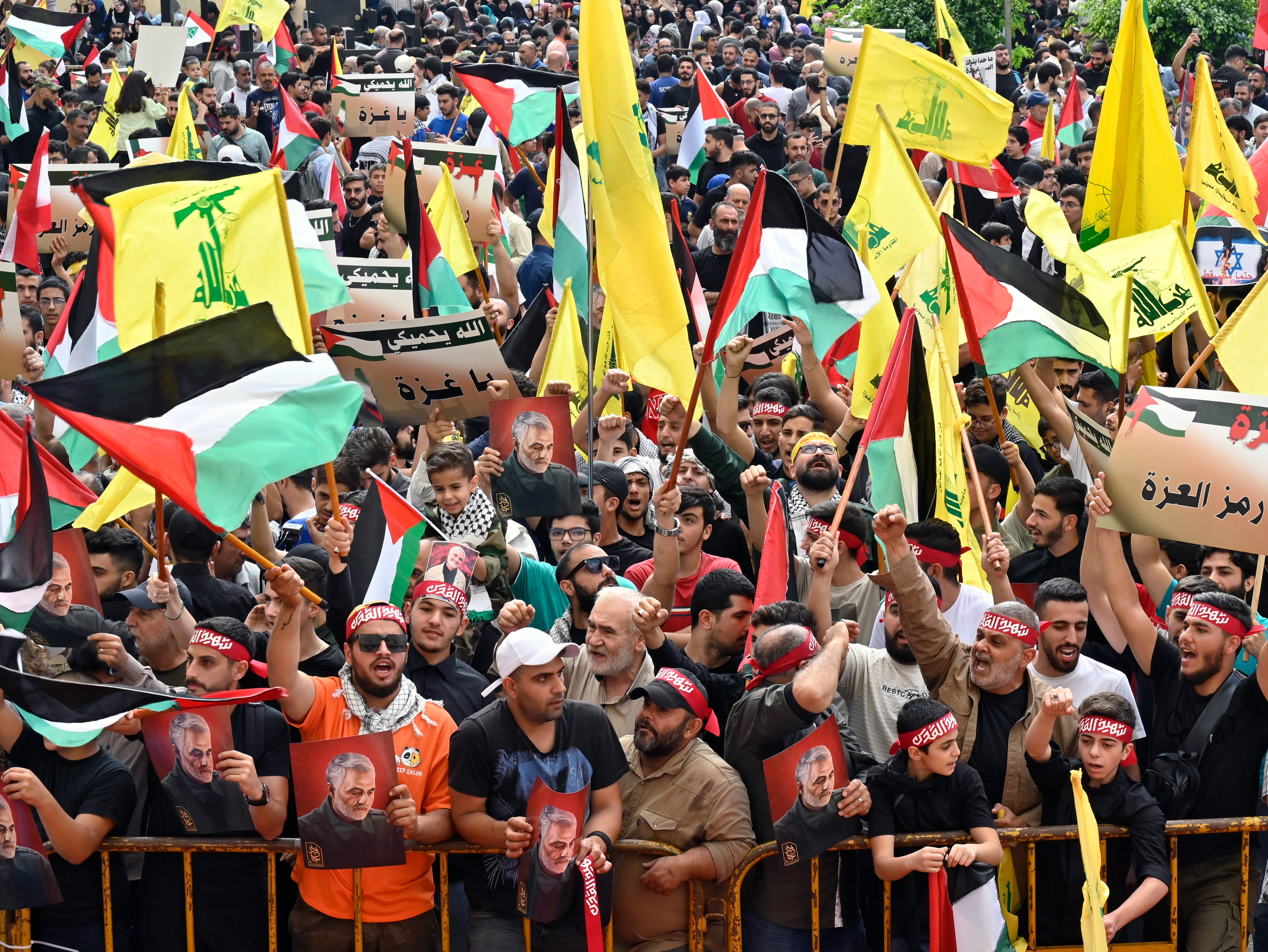 <p>Protesters wave Palestinian, Lebanese and Hezbollah flags in Beirut </p>