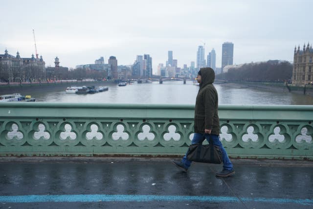 A man walks across Westminster Bridge in central London earlier this year (PA)