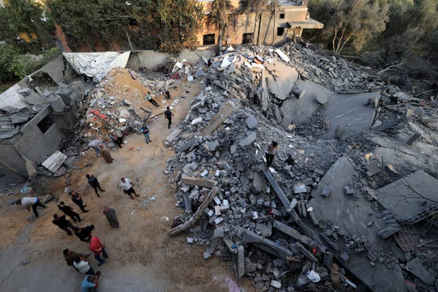 <p>People inspect the damage to a building after Israeli strikes in the Rafah camp on the southern Gaza Strip</p>