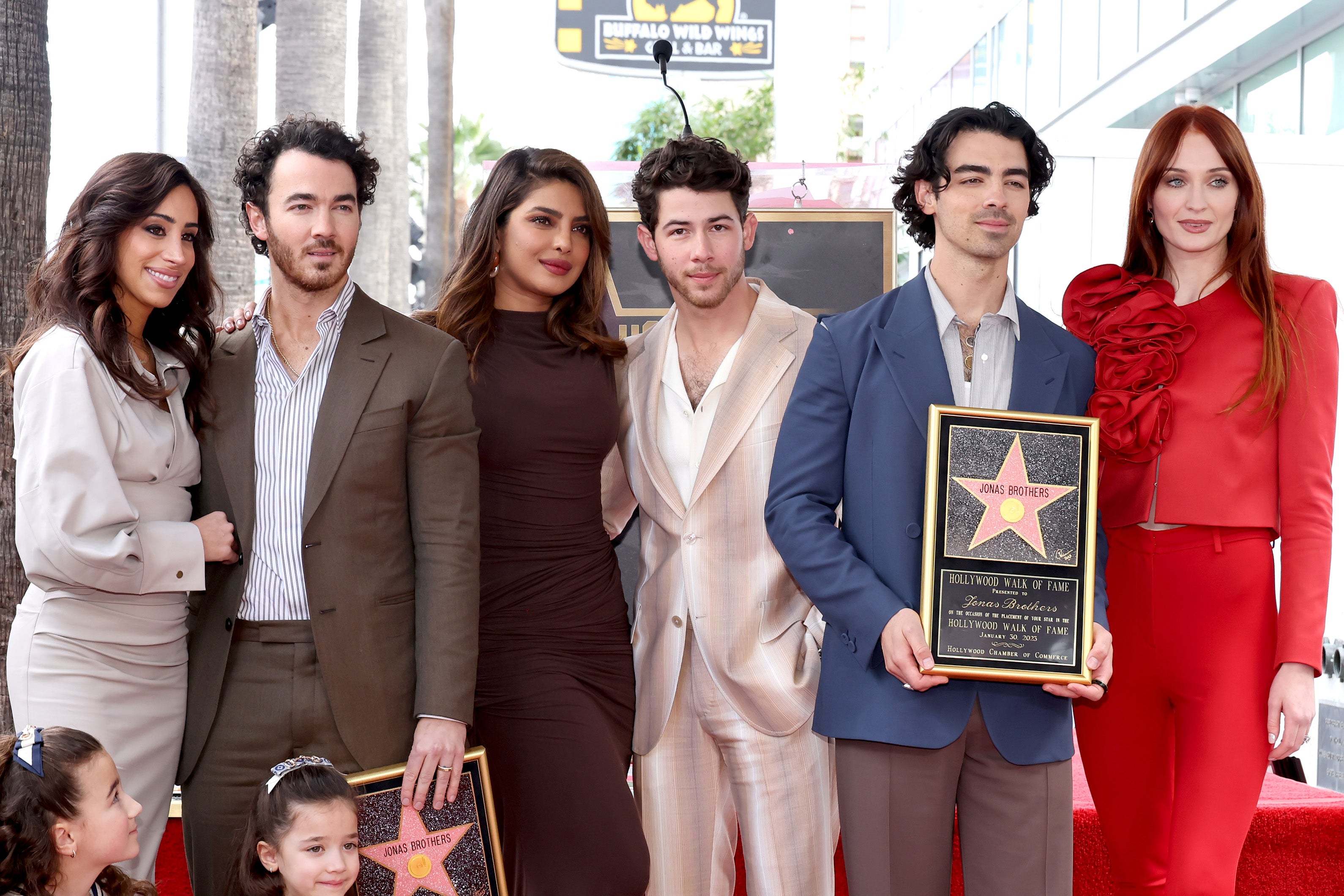 Turner (far right) and Chopra (third from left) with the Jonas Brothers in January