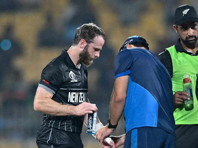 <p>New Zealand’s captain Kane Williamson is being helped by a medic</p>