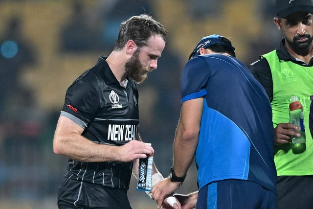 <p>New Zealand’s captain Kane Williamson is being helped by a medic</p>