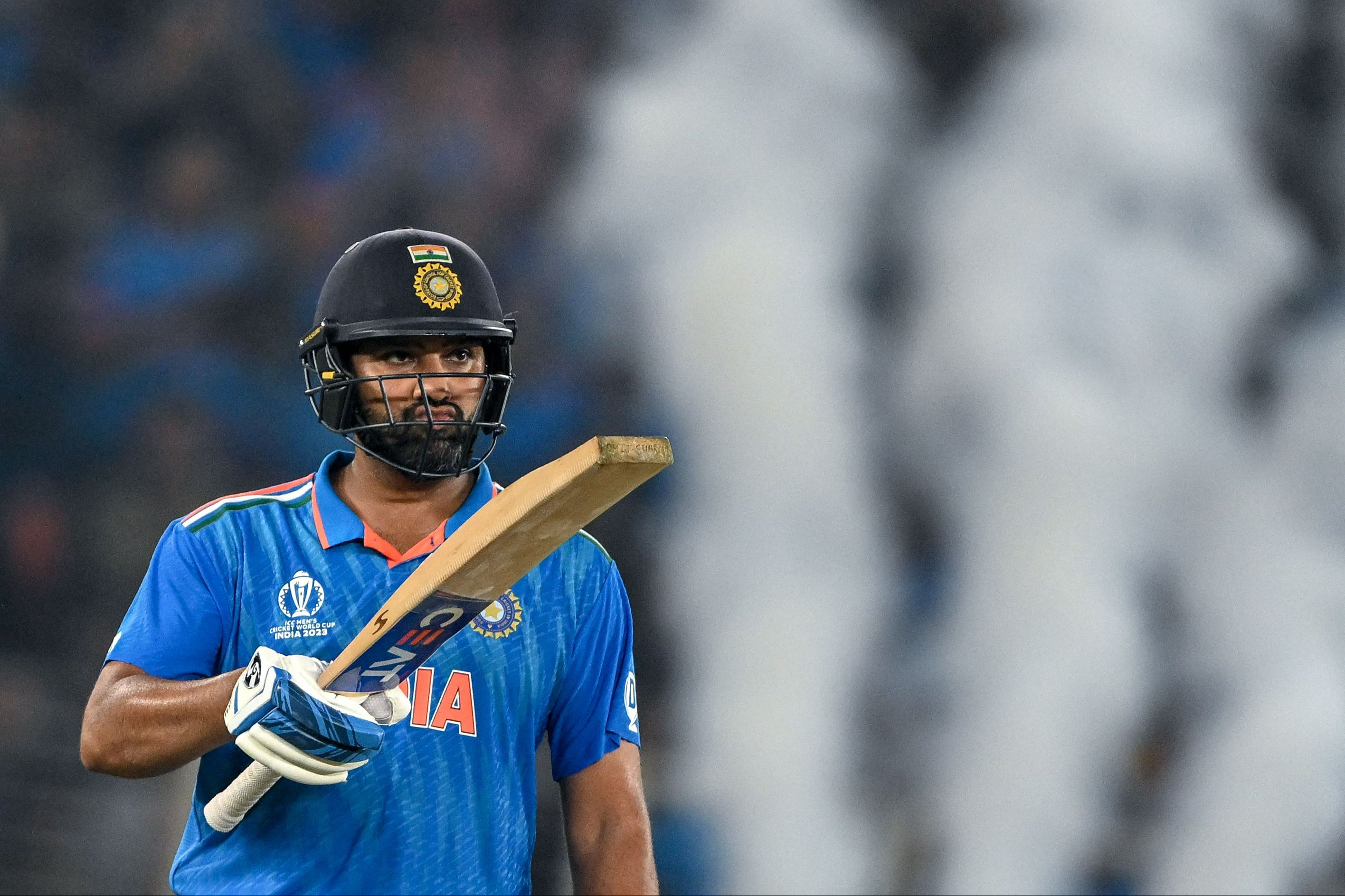 India's captain Rohit Sharma celebrates after scoring a half-century