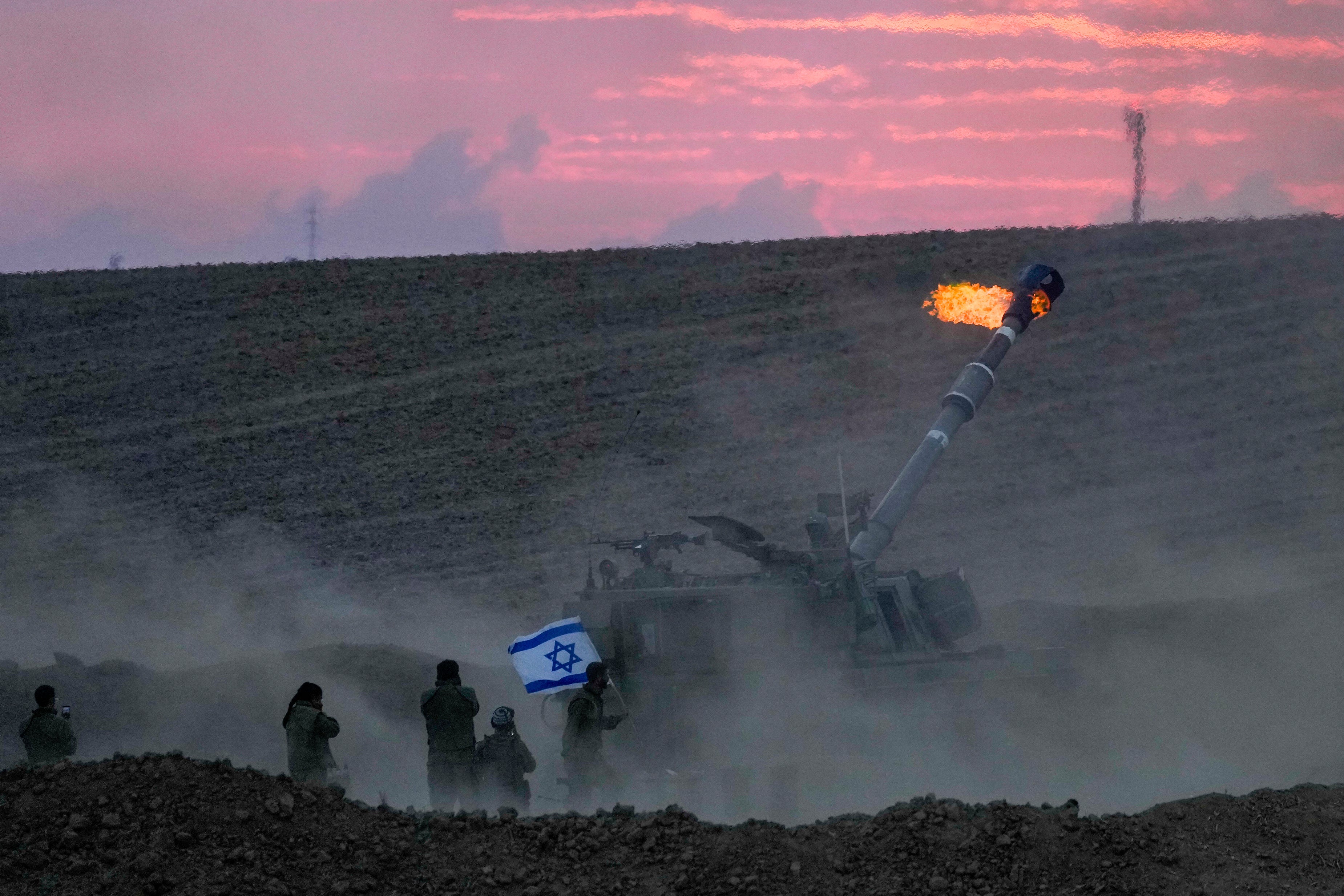 An Israeli mobile artillery unit fires a shell from southern Israel towards the Gaza Strip