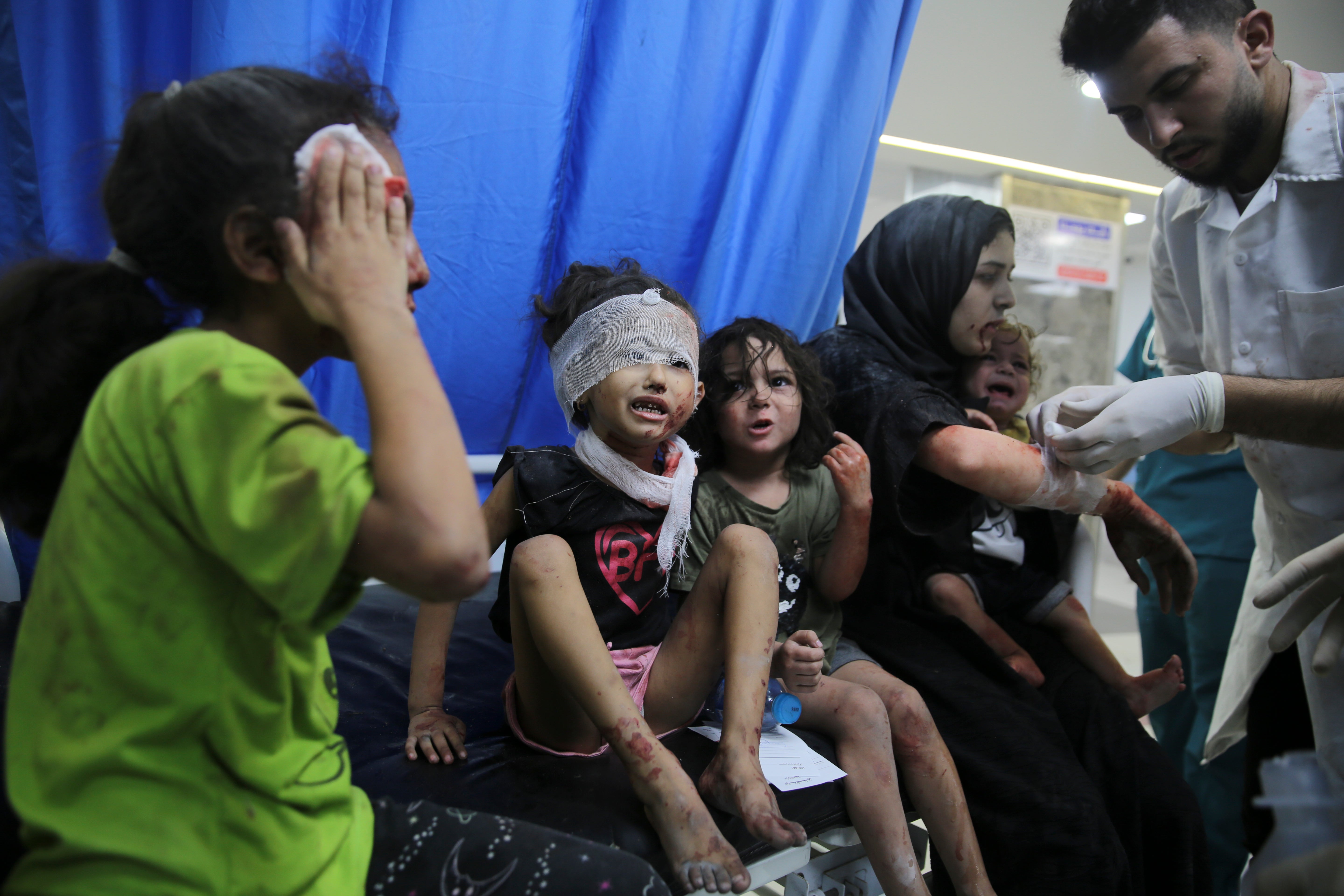 Palestinian children wounded in Israeli strikes are brought to Shifa Hospital in Gaza City