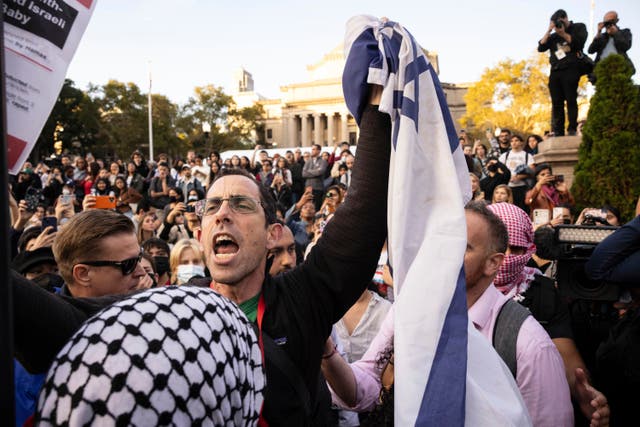 <p>FILE - A pro-Israel demonstrator shouts at Palestinian supporters during a protest at Columbia University, Thursday, Oct. 12, 2023, in New York. As the death toll rises in the Israel-Hamas war, American colleges have become seats of anguish with many Jewish students calling for strong condemnation after civilian attacks by Hamas while some Muslim students are pressing for recognition of decades of suffering by Palestinians in Gaza. (AP Photo/Yuki Iwamura, File)</p>