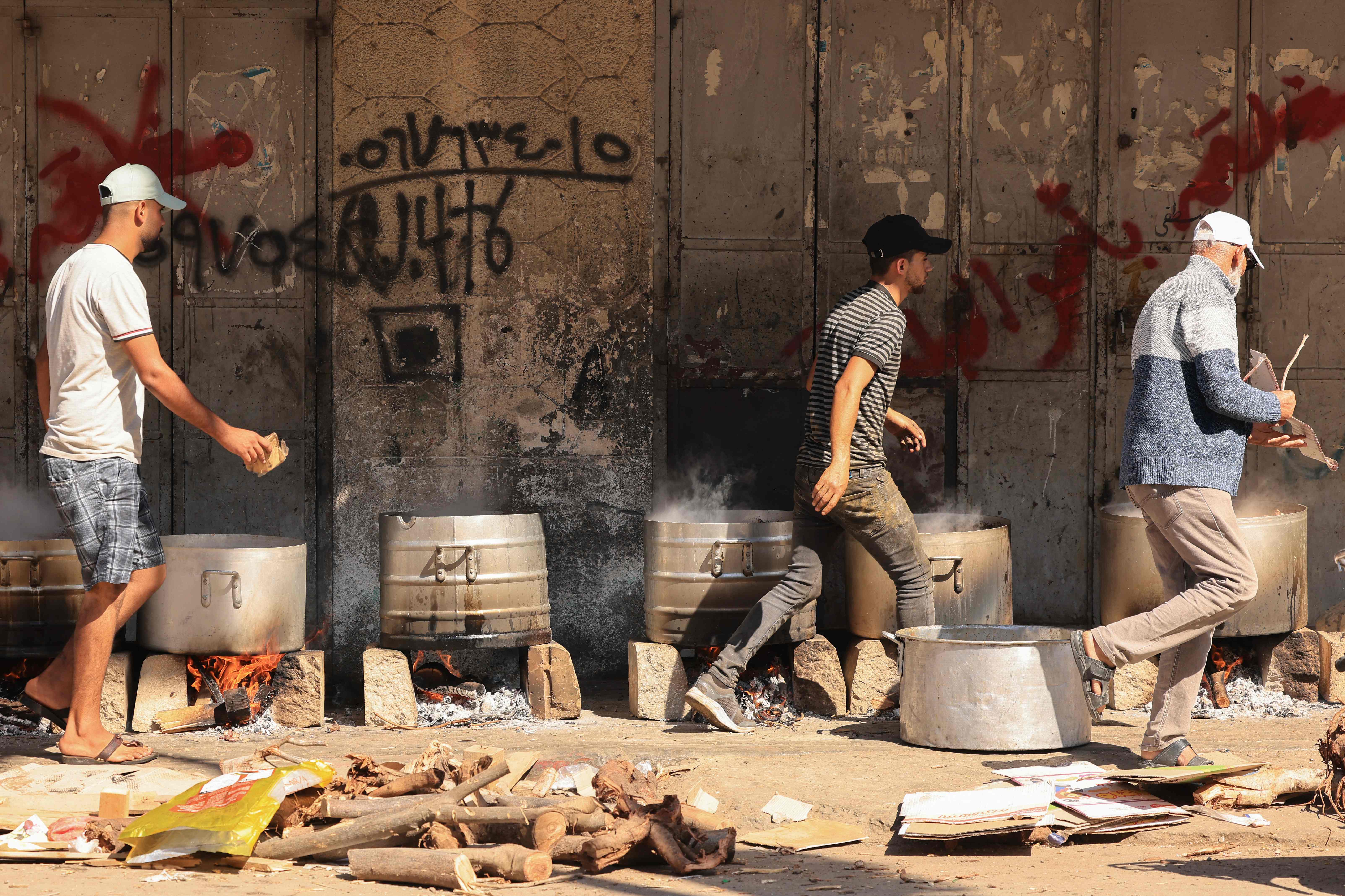 People cook on firewood amid shortages of fuel and gas in Gaza
