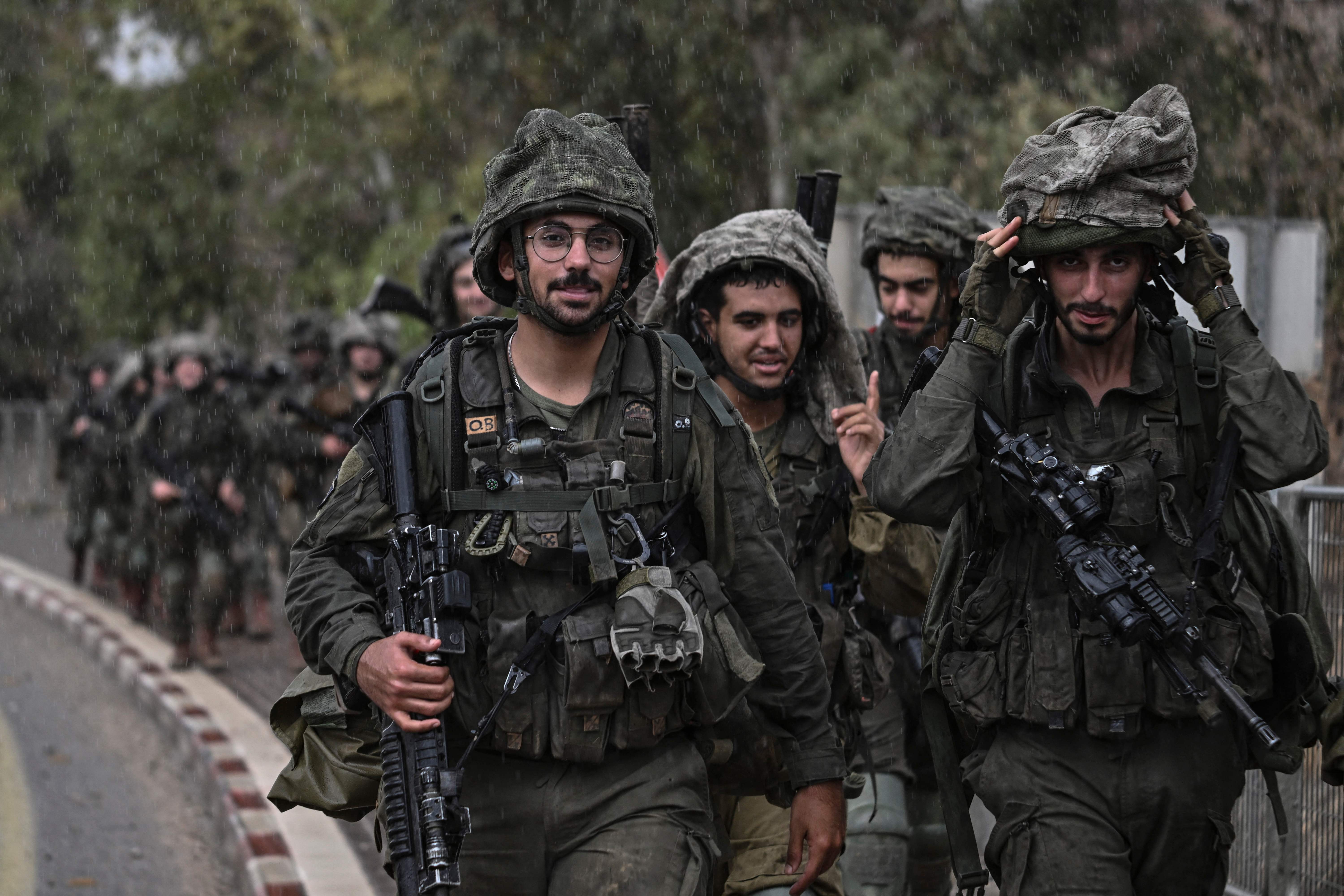 Israeli army soldiers patrol at an undisclosed position in northern Israel near the borer with Lebanon on October 15