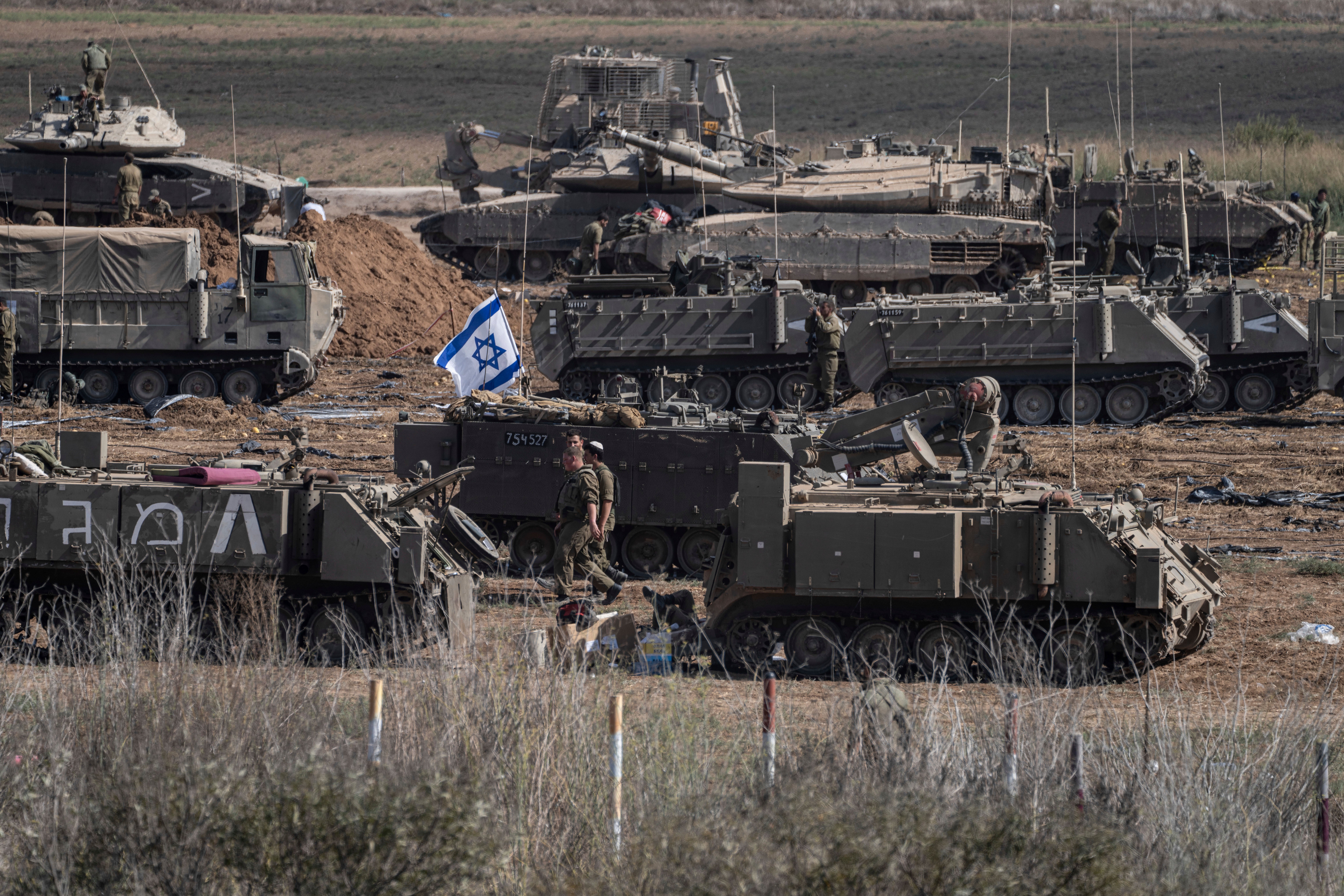 Israeli soldiers gather in a staging area near the border with the Gaza Strip in southern Israel