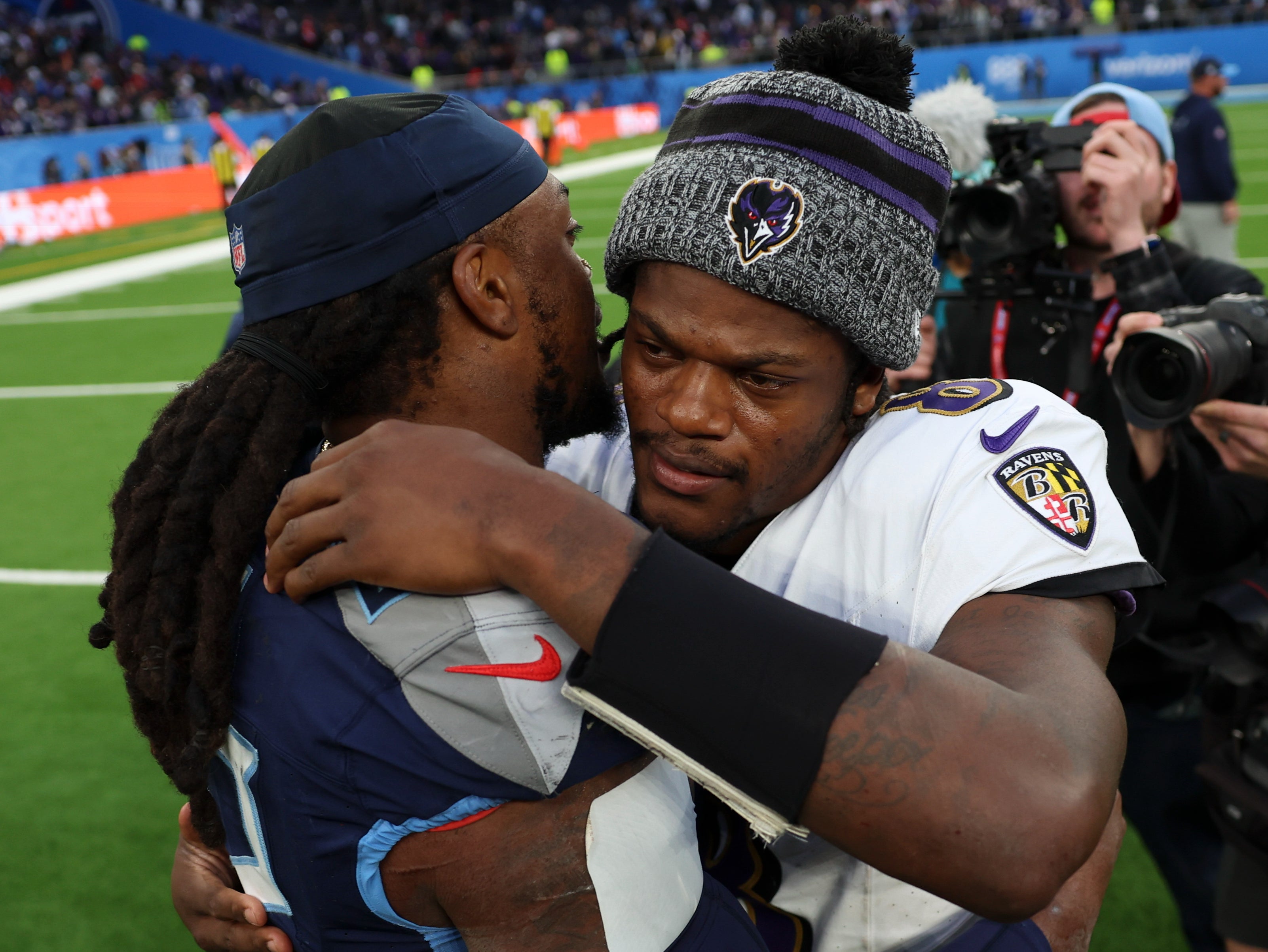 Tennessee Titans running back Derrick Henry and Baltimore Ravens quarterback Lamar Jackson embrace