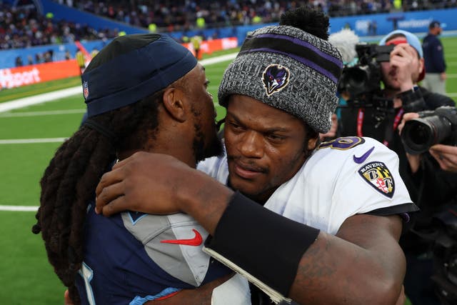 <p>Tennessee Titans running back Derrick Henry and Baltimore Ravens quarterback Lamar Jackson embrace</p>
