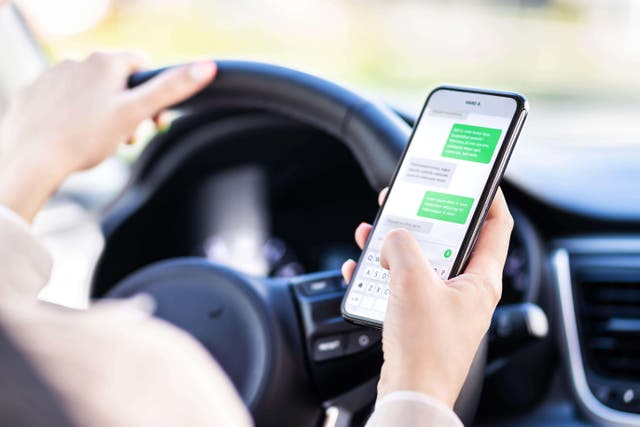 More than 600,000 British drivers face disqualification with ‘one touch of their phone’, a road safety charity has warned (Alamy/PA)