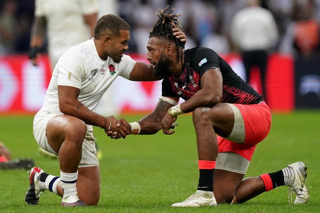 England’s Ollie Lawrence, left, consoles Fiji’s Waisea Nayacalevu after the World Cup quarter-final in Marseille (Mike Egerton/PA)