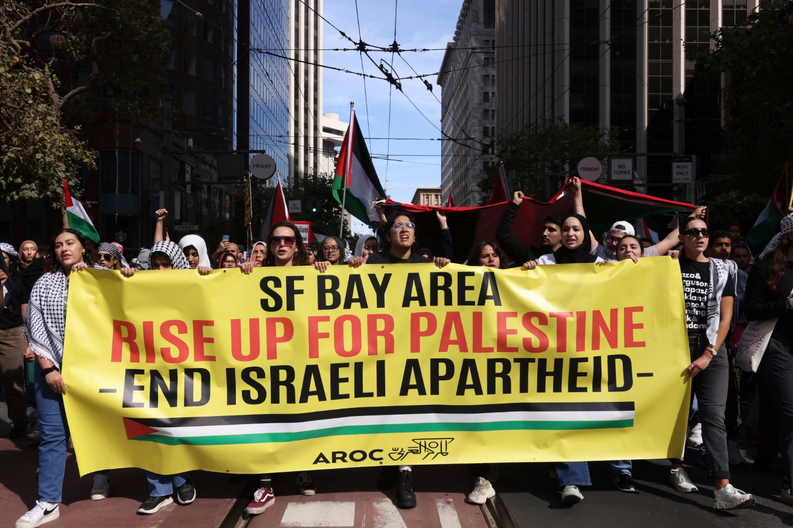 People march during a pro-Palestinian rally that began at Harry Bridges Plaza on Saturday