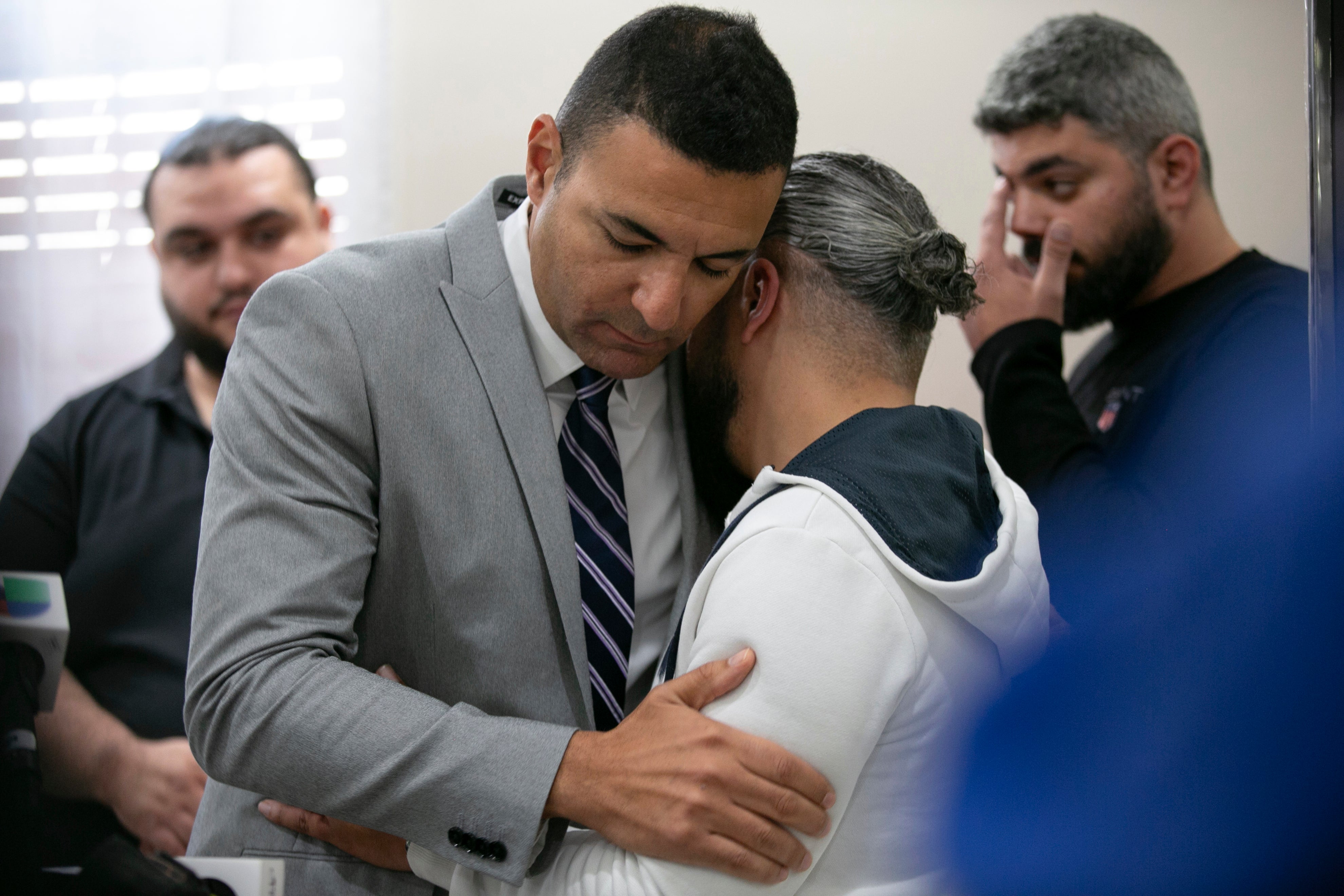 Ahmed Rehab, left, executive director of the Chicago chapter of the Council on American-Islamic Relations, embraces Odey Al-Fayoume, father of Wadea Al-Fayoume, 6