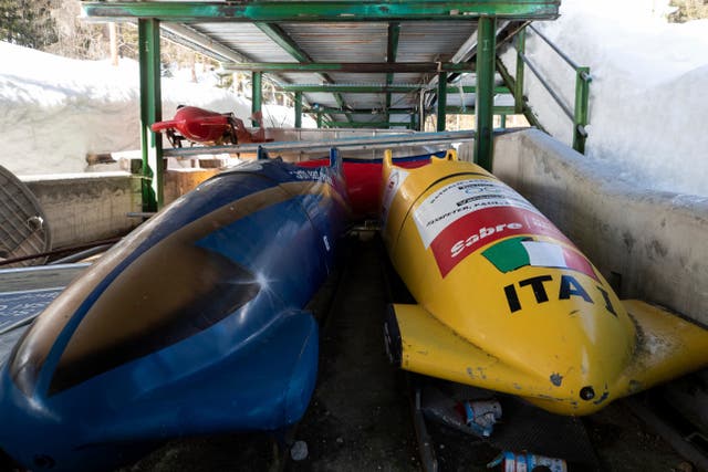 <p>Bobsleds are parked next to the track in Cortina d'Ampezzo, Italy,</p>