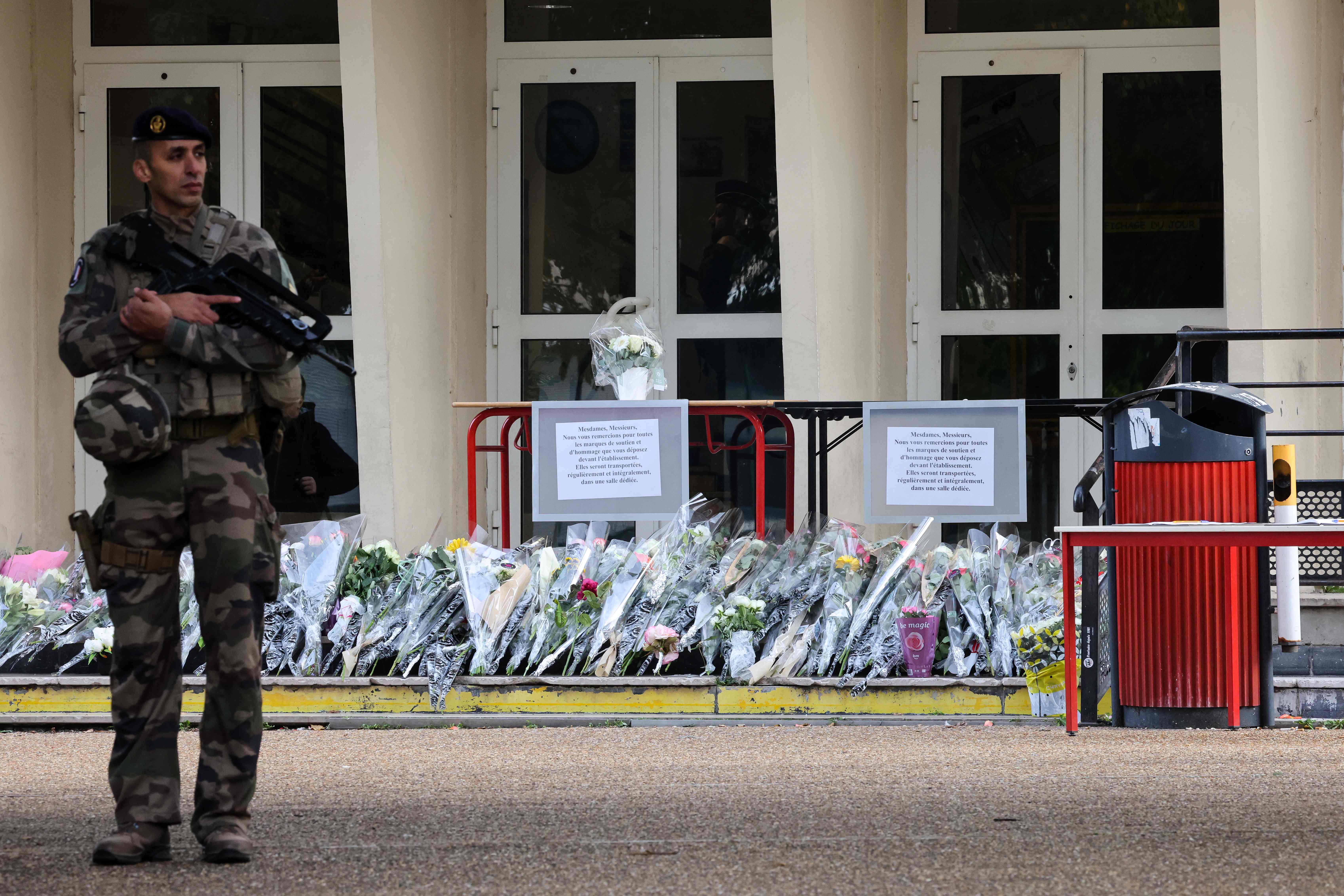 A French military serviceman stands guard in front of the Gambetta high school during the evacuation