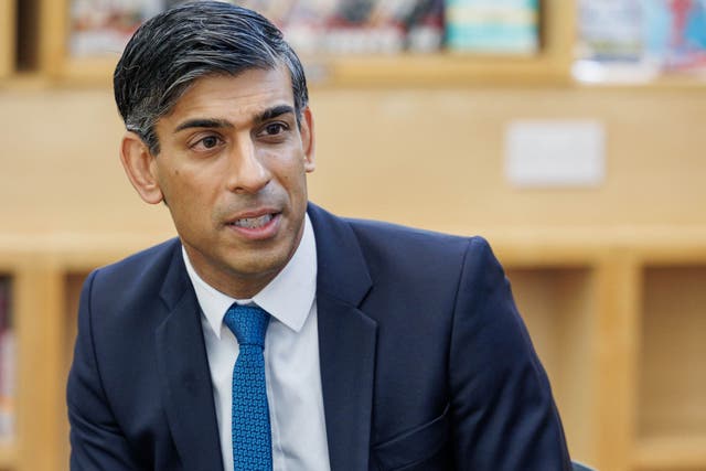 Prime Minister Rishi Sunak talking to sixth form students during a visit to a school in north London (Jonathan Buckmaster/Daily Express/PA)