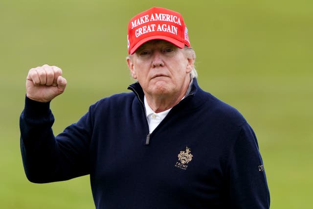Former US president Donald Trump playing golf during his visit to the UK in May (PA)