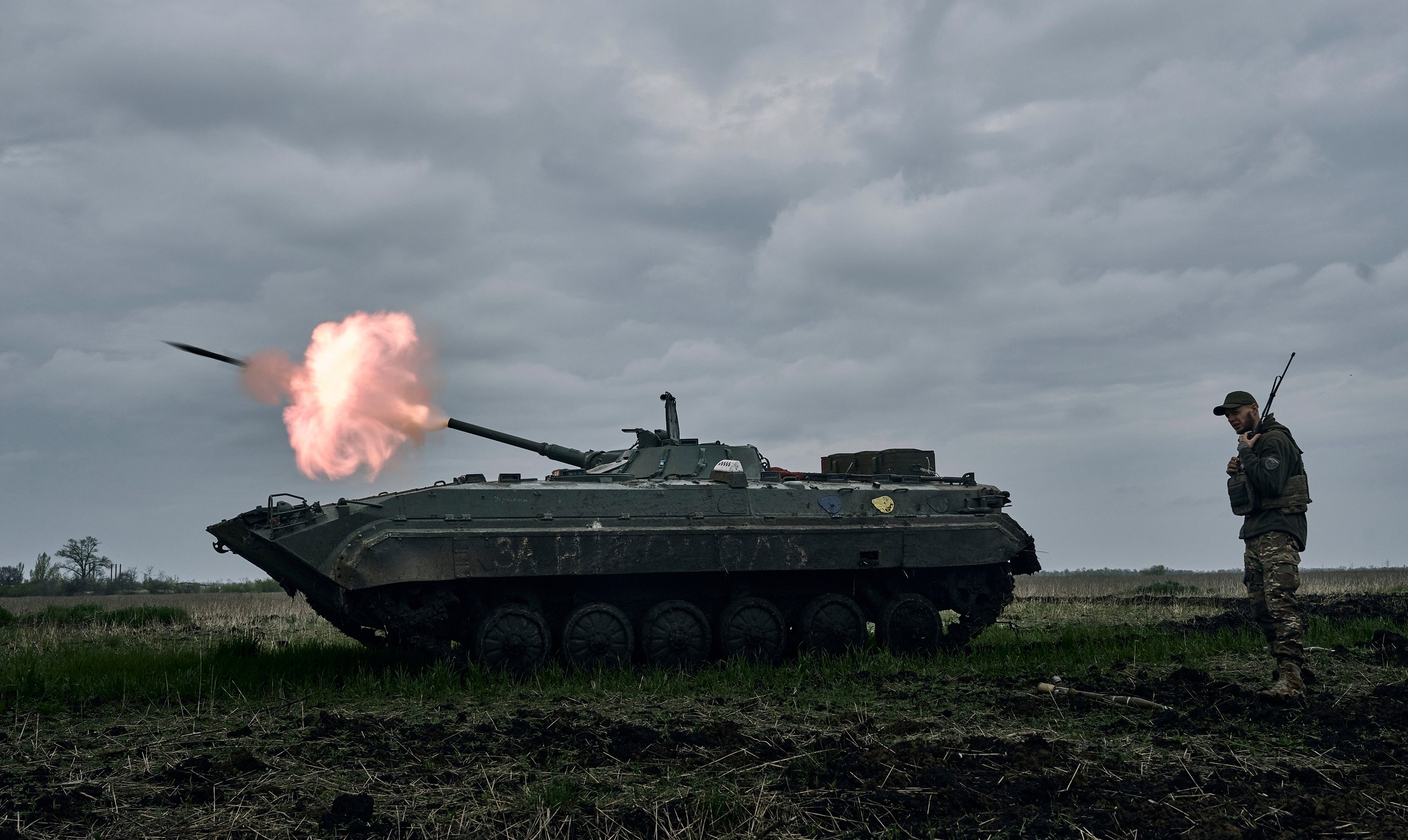 A Ukrainian APC fires towards Russian positions near Avdiivka, in the Donetsk region