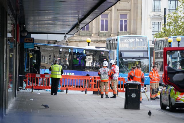 Emergency services at the scene of a bus crash at the City Tower building close to Manchester’s Piccadilly Gardens Metrolink stop (Peter Byrne/PA)