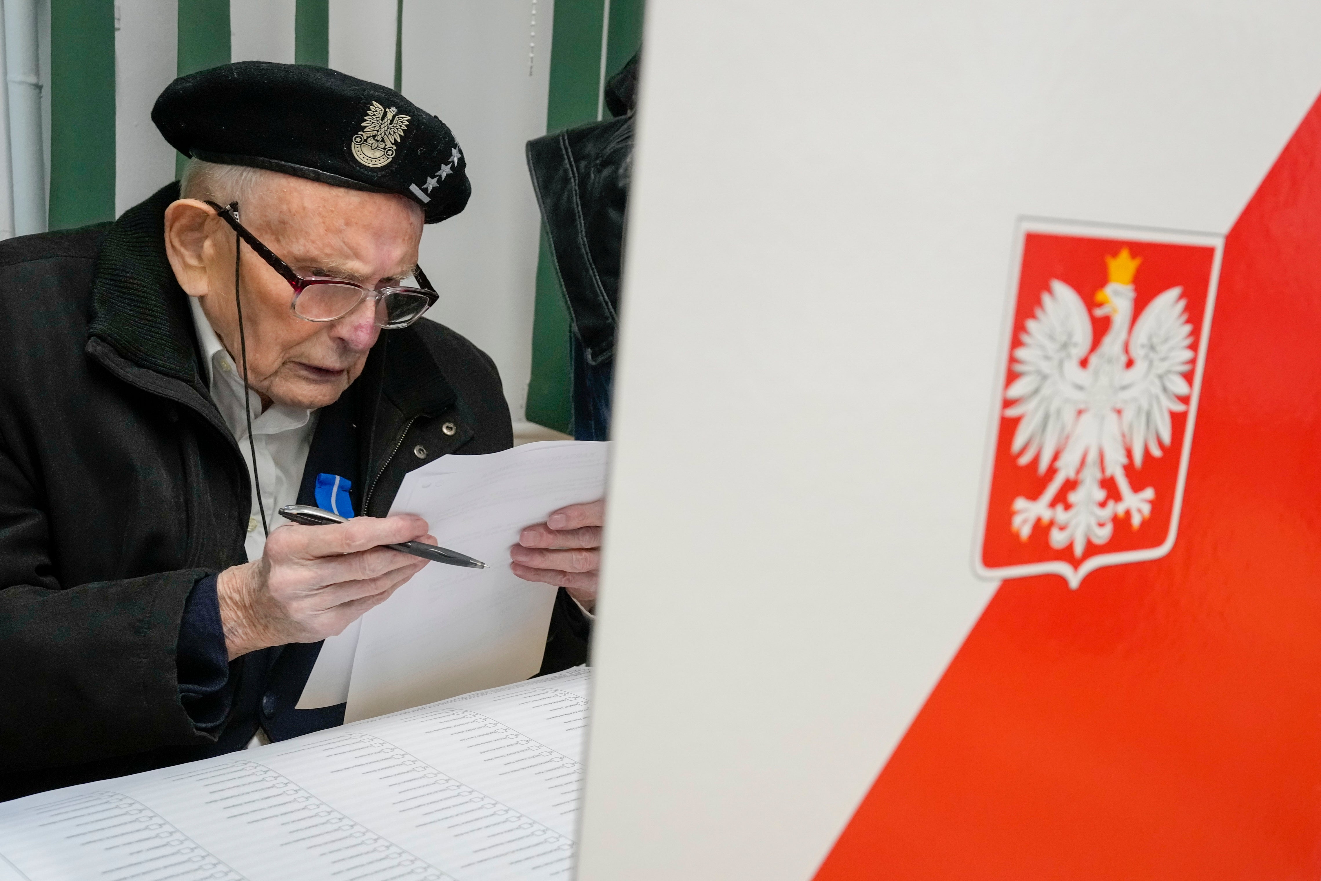 A man prepares his ballot in Warsaw on Sunday